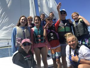 students posing for the camera on a boat