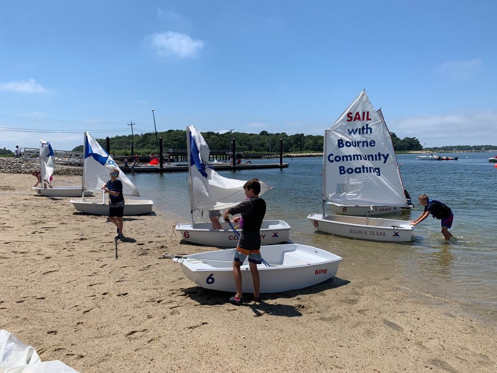 students rigging prams on the beach
